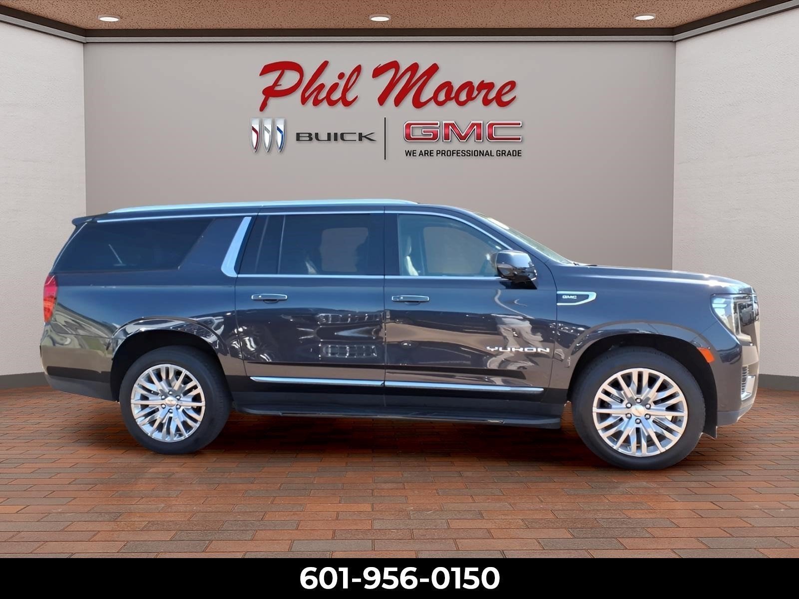2023 GMC Yukon XL SLT in Titanium Rush Metallic — front three-quarter view