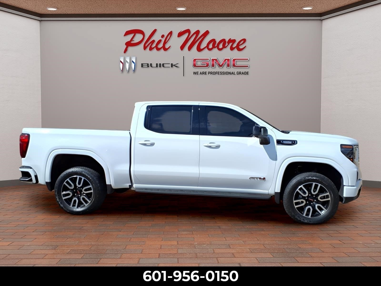2025 GMC Sierra 1500 AT4 in Summit White — front three-quarter view